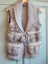 Ladies lovely knitted waistcoat, extra layer of warmth for the winter. With Faux fur detail and pompom waist tie....