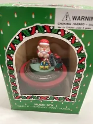 Vintage Christmas Music Box Santa And Revolving Train In Original box. UnusedA musical delight features with a toy...