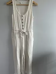This is a Loveriche brand white linen blend jumpsuit, size small. The jumpsuit has long pants and is sleeveless. There...