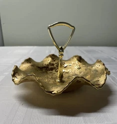 No cracks or chips found , bottom of dish has Dixon Art Studios 22kt Gold, which must indicate the coating. Pretty! (Gl)
