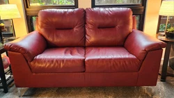 RED LEATHER LOVESEAT SOFA COUCH.  BARELY USED. 66 WIDE 38 X 38. SUPER COMFORTABLE. IN DOWNTOWN SAN LUIS OBISPO