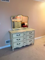 Long dresser with 6 drawers and Mirror; in yellow beige with gold trim and victorian drawer pulls.