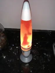 Lava Lite Lamp Pink. Plastic Gray Base.. Some haziness in the glass due to age of lava lamp.