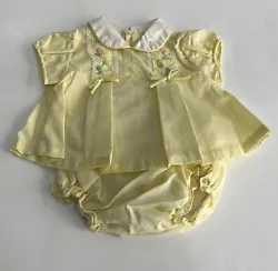 Sweet embroidered flowers and lace trim on yellow smocked and pleated swing top. buttons up the back. Baby Girl 2 pc...