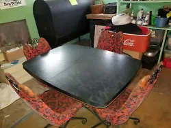 Vinyl and wrought iron Red with Black designs chair. Slight Discoloring from use. BRODY Table an chairs. Table weighs...