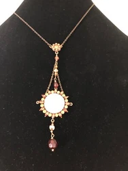 I believe the stones in this piece or not real. It is Amber colored. It has a main accent that looks like it could’ve...