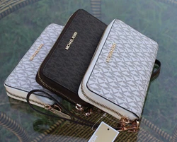 Traveling light just got easier with our latest smartphone wristlet. Designed in crossgrain leather, this chic...