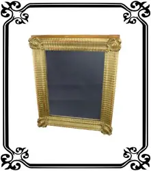 A beautiful antique French mirror from the nineteenth century. The Empire (1820) mirror wall hanging is made of gilded...