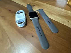 This Apple Watch Series 1 has a gold aluminum case and a dark brown fluoroelastomer band, making it a stylish accessory...
