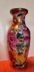 This vase is from the 1920s and of China craftmanship. Its very colorful and is imbedded with gold flake and gold trim....