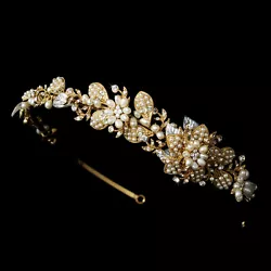 Floral and leaf design encrusted with clear rhinestones and ivory pearl accents is perfect for any classic bride...