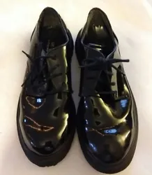 Black Patent leather. Shiney dress shoe. Little wear on inside. Outside good.