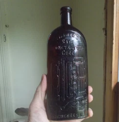 A shiny clean bottle. This is an early glasshouse marked variant with the slug plate emb panel.you can plainly see the...