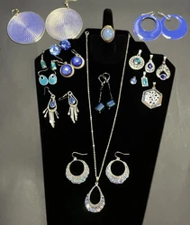This lot is full of charms, pendants earrings, necklace and a ring. All are blue color or contain blue stones. The...