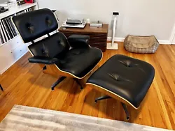 Eames lounge chair and ottoman from Herman Miller in like new condition. Walnut shell with black leather upholstery....