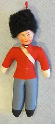 He has a celluloid head with middle seam and painted features with rosy cheeks. There is a small spot on the off white...