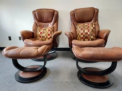 Set of two leather chairs with ottomans can be used for office or living room. In good condition. Small stain on seat...