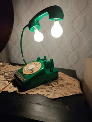 Upcycled Antique Rotary Telephone Lamp. The lamp has two rotary switches, one for the two lamp bulbs, the other for a...