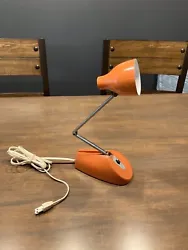 Its bright orange color and very clean. This desk lamp features a clean corded electric power. Made of plastic and...