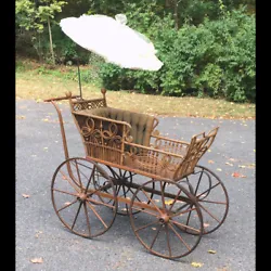 Late 1800s The Heywood Wicker Baby Carriage. Natural finish wicker, original pleated tufted upholstery, cane seat area....