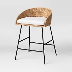 •Woven bar stool with a barrel-style silhouette •Padded seat cushion lends comfortable sitting experience •Metal...