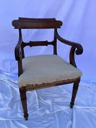Antique French Empire arm chair. In particular, chair require upholstery and appears to have a crack on the front left...