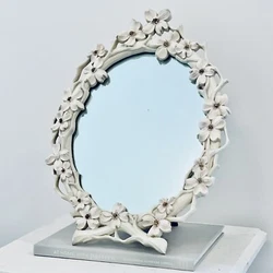 It has an attractive Victorian or Art Nouveau floral dogwood pattern. I’m not 100% sure if it’s wood or resin....