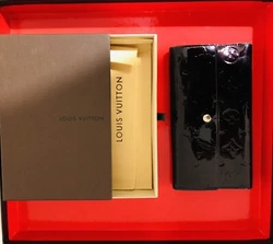 Louis Vuitton, Portefeuille SARAH, en cuir verni. Monogram noir Charmant modèle int légèrement patinéQq marques...