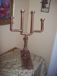 THIS UNIQUE CANDELABRA IS MANUFACTURED WITH COPPER PIPES AND FITTINGS WITH A WOOD BASE. A VERY ATTRACTIVE THAT WILL GET...