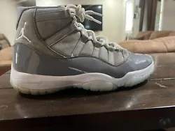 Elevate your sneaker game with these Air Jordan 11 Retro Cool Grey 2021 sneakers in size 12. The silhouette features a...
