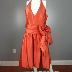 Alfred Angelo burnt orange halter dress is fully lined with boning/wires in bodice. Halter has hook and eye closure,...