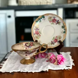 Beautiful lusterware floral footed teacup and saucer.