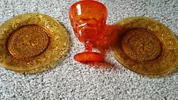 Great for window displays! 2 Ornate Amber Glass Plates & Orange Candy Dish on Pedestal. Nice unusual find.