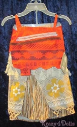 Overlapping panel with sequin accents and lace trim. Short top with folk art pattern.