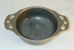 This deep porringer has two handels with open design. It has round base with a shallow foot and is stamped with the...