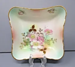 Square with wild rose painted design with gold accents and rim around the top. Very nice condition except for a chip on...