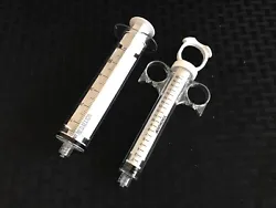20mL size has ring grip, locking ring plunger, and fixed male luer connector hub. 60mL size has regular handle and...
