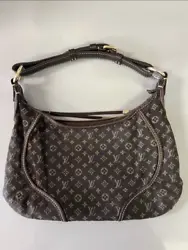 This is an authentic LOUIS VUITTON Mini Lin Monogram Manon PM in Ebene. This chic hobo is crafted of ebene brown Louis...