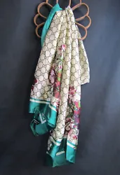 This beautiful Gucci silk scarf has the classic pink floral design with a green border and beige background. It is in...