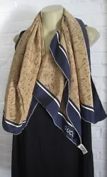 Deep navy blue and brown, cream pinstripe. Oversized scarf from the House of Gucci. Dual colored hem.