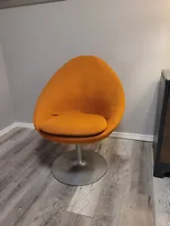 This vintage swivel chair is a unique addition to any home. The bright orange color adds a pop of vibrancy to any room....
