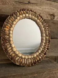 Beautiful 15x13 Sea shell crusted mirror done in a neutral palette. Brown, ivory and tan shells with sand in between....
