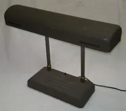 This is a really neat deco-style desk lamp. It works great and still wears it original brown paint with brass accents....