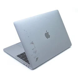 It shows other signs of use, including heavy scratches and dents on the casing, worn out keys, and scratches on the...
