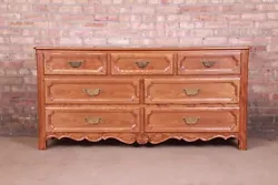 Carved oak, with burl wood drawer fronts and original brass hardware. An exceptional French Provincial style...