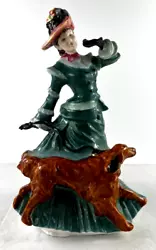 Walking her red setter dog, you can see her shoe poking out of the bottom. Made in England signed by artist Valerie...