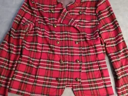 The jacket features a trendy plaid pattern in red, with an open front and logo button closure. The long sleeves with...