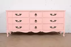 By Henredon. A gorgeous French Provincial Louis XV style nine-drawer triple dresser or credenza. Pink lacquered solid...