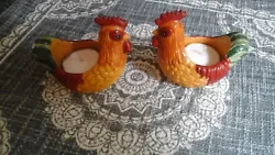 Set of two cheerful Rooster candle holders. Holds a tealight candle (which is included). Colors are a bit more vivid...