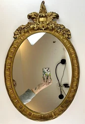 Vertical hang with ornate florals and foliate crests to the top. Used condition. Mirror has a few minor spots of...